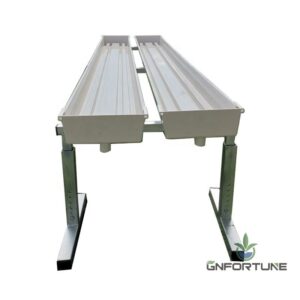 White PVC substrate gutter pair mounted on galvanized metal stands with drain outlets