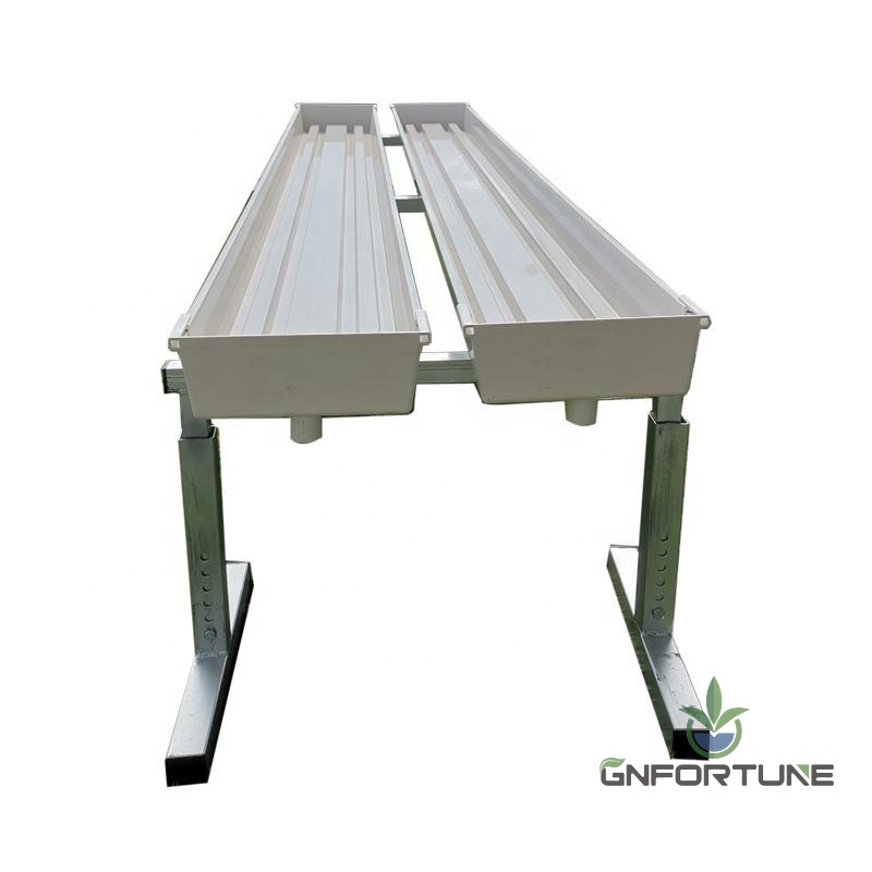 White PVC substrate gutter pair mounted on galvanized metal stands with drain outlets