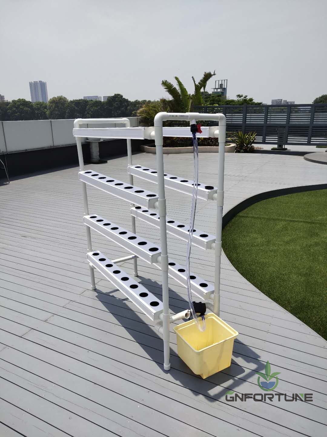 Full mini NFT channel system setup on a rooftop deck with city skyline behind